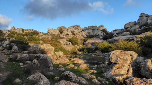 Rocks on landscape against sky