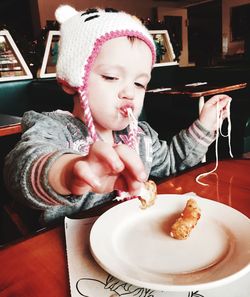 Toddler eating food at restaurant