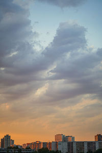 Buildings in city against sky during sunset