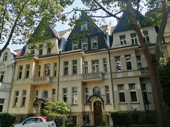 Low angle view of buildings and trees in city