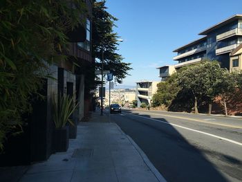 Empty road along buildings