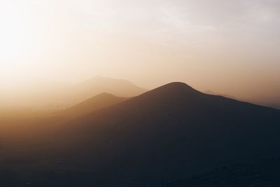 Scenic view of silhouette mountain against sky during sunset