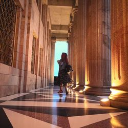 Woman walking in corridor of building