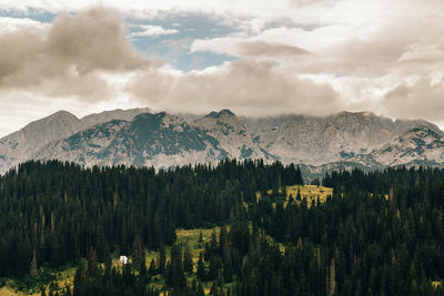 Scenic view of mountains against cloudy sky