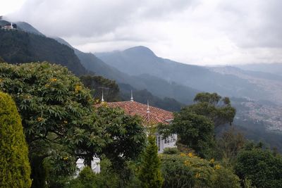 Scenic view of trees and mountains against sky