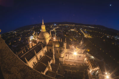 High angle view of illuminated buildings in city at night