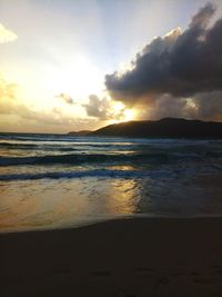 View of sea against cloudy sky during sunset