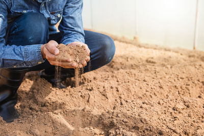 Low section of man working in mud