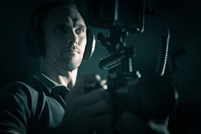 Portrait of young man holding camera