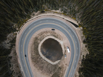 Aerial view of vehicles on road amidst trees