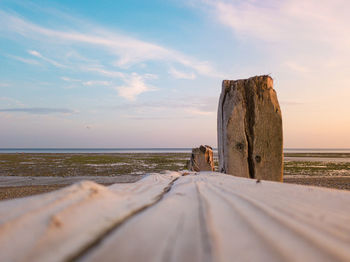 Surface level of empty beach against sky