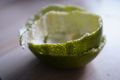 Close-up of green fruit on table