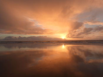 Scenic view of sea against orange sky