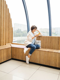 Mindful woman in eyeglasses is texting in smartphone. casual wear woman with gadget. 