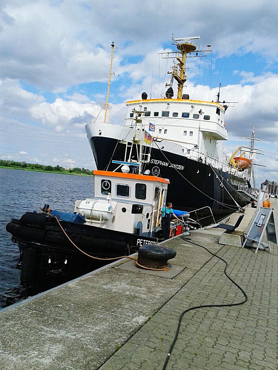 transportation, mode of transport, sky, nautical vessel, water, cloud - sky, moored, boat, sea, cloudy, cloud, building exterior, travel, built structure, harbor, land vehicle, architecture, outdoors, day, car