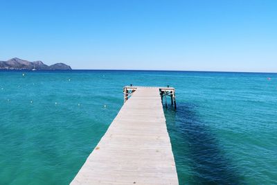 Scenic view of sea against clear blue sky