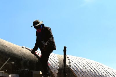 Low angle view of man against clear sky