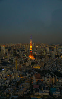 Aerial view of illuminated tokyo tower amidst cityscape against sky at night