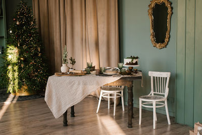 Beautifully decorated and served dining christmas table in the living room