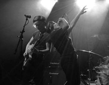 Panoramic view of men playing music at night