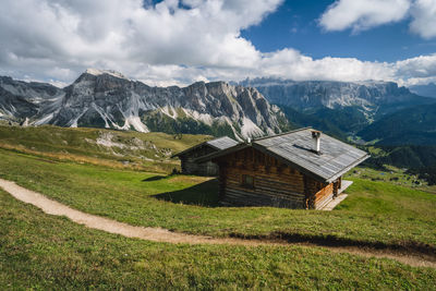 Scenic view of field and mountains against sky