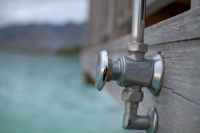 Closeup of pipe showing reflection, beautiful ocean in background 