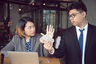 Mid adult man using mobile phone at home