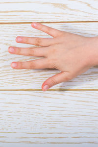 Midsection of woman touching wooden table