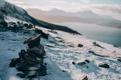 Stack of stones on snow covered land