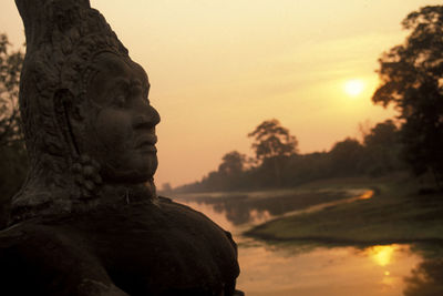 Close-up of statue against sky during sunset