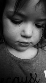 Close-up portrait of girl looking down