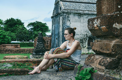 Young woman sitting outdoors