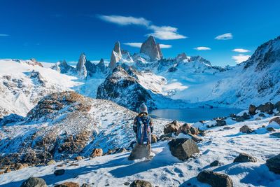 Panoramic view of snowcapped mountains against blue sky