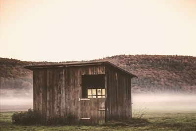 Abandoned built structure on field against clear sky