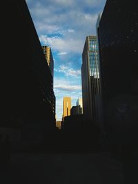 Silhouette buildings against sky in city