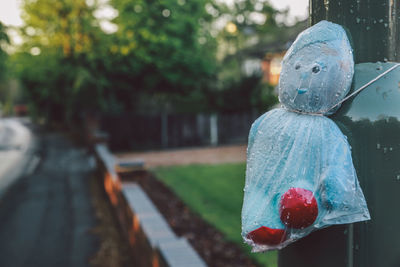 Toy covered with plastic bag tied on pole