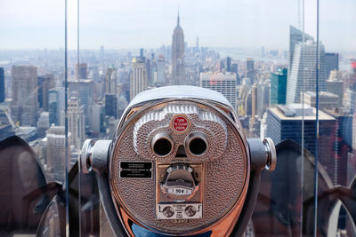 Tourist telescope looking over new york city skyline