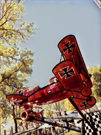 Low angle view of red tower against sky