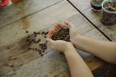 High angle view of woman hand on table