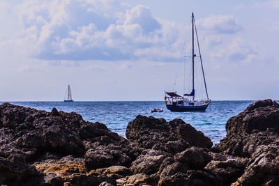 Sailboat sailing on sea against sky