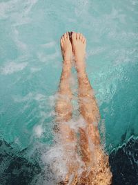 Low section of woman swimming in sea