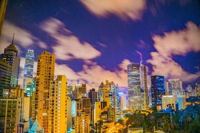 Illuminated cityscape against sky at night