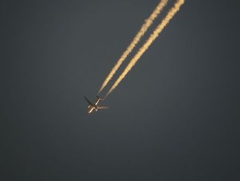 Low angle view of airplane flying in sky