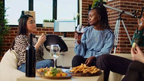 Portrait of smiling friends sitting on table