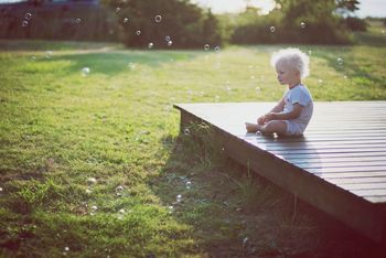 Toddler sitting on deck