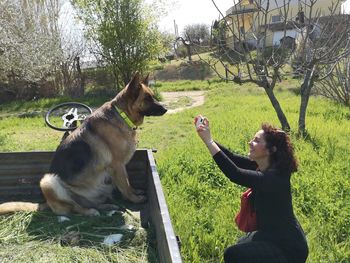 Woman with dog on field