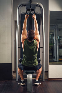 Rear view of woman exercising in gym