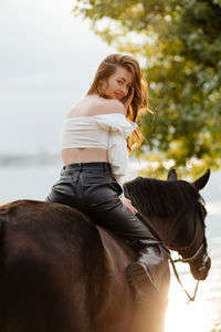 Side view of young woman using mobile phone