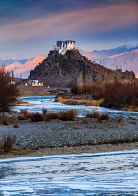 Built structure on snow covered land during sunset