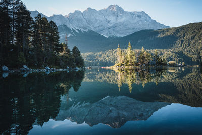 Scenic view of lake and mountains against sky